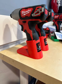 Milwaukee M12 drill seated in tabletop holder