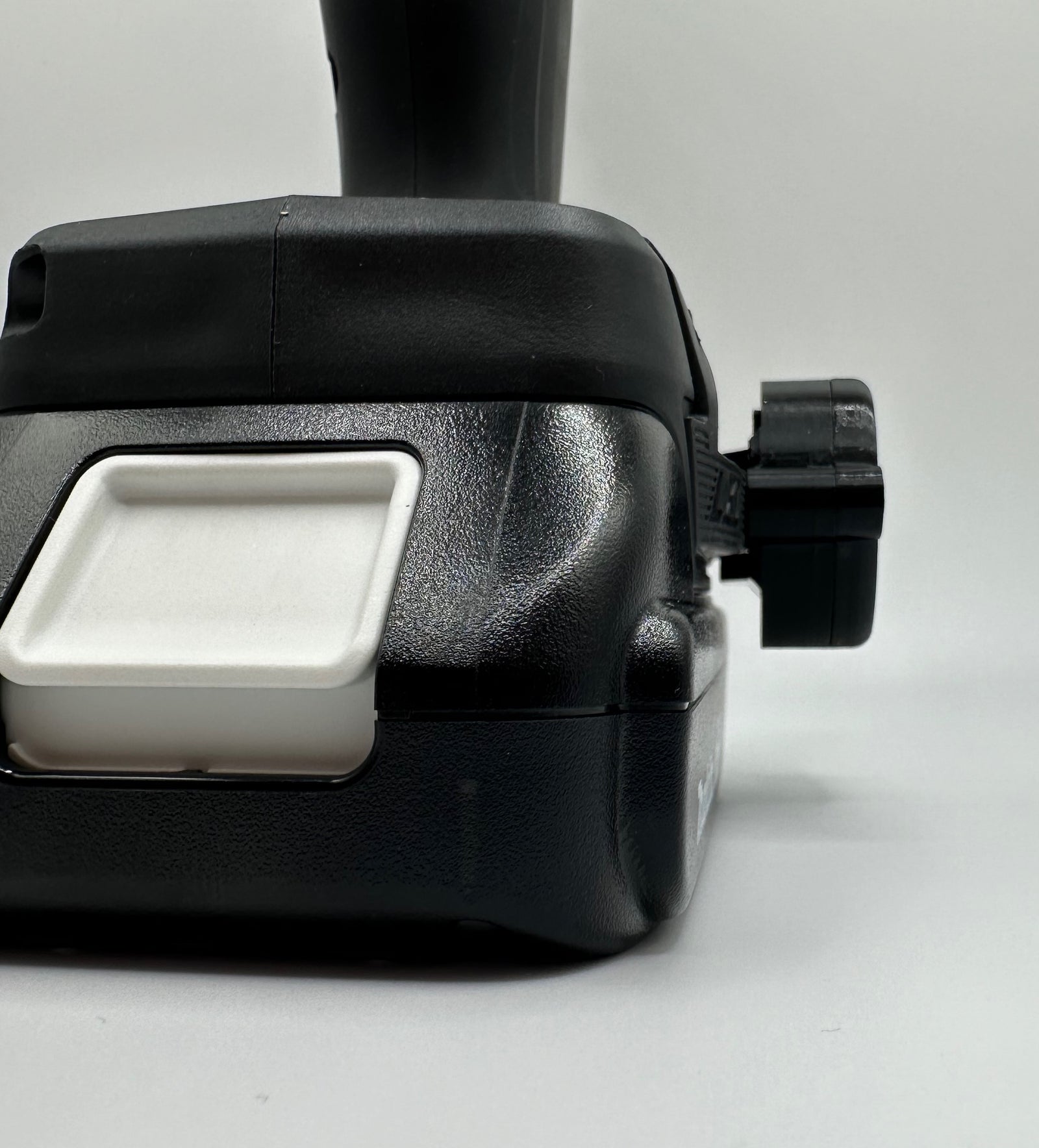 Makita AirTag holder close-up showing AirTag slot